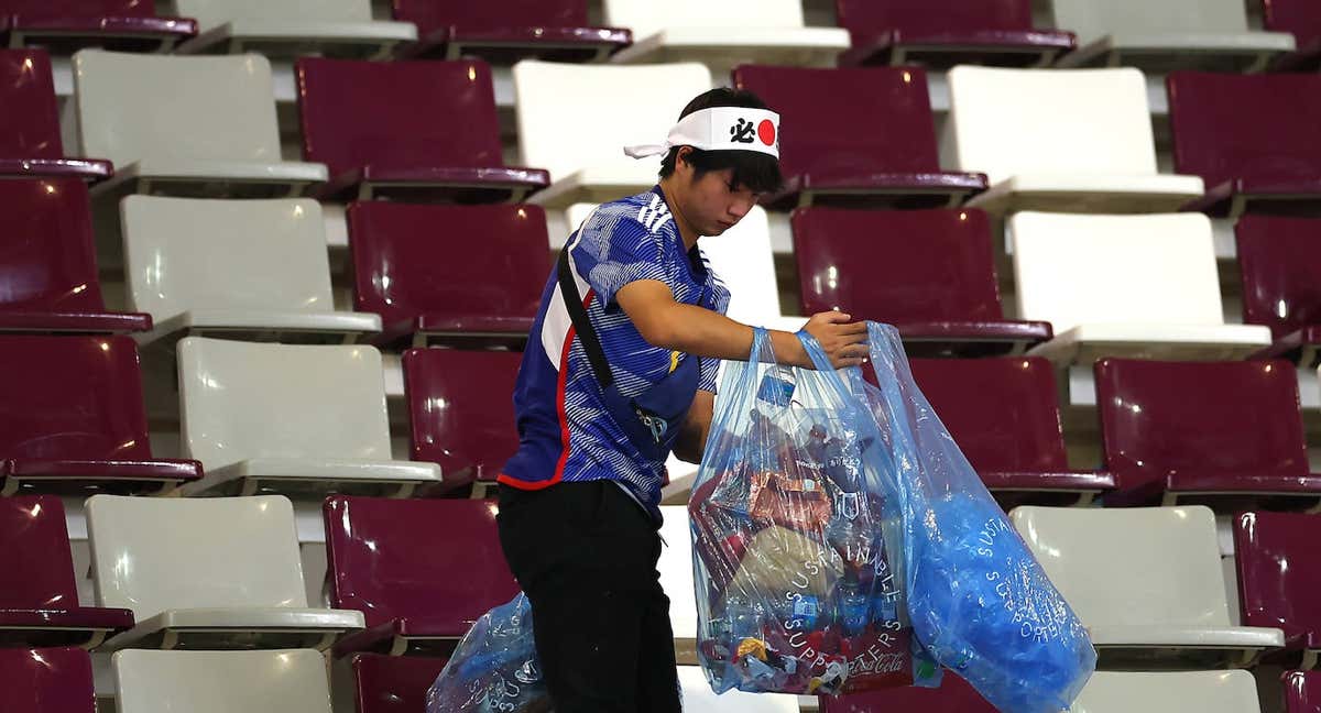 Un aficionado japonés limpia la basura de la grada después de la victoria de su selección ante Alemania. /Getty