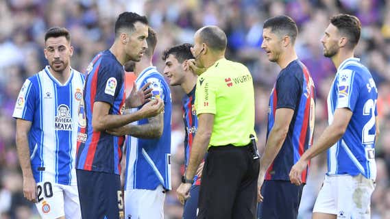 Mateu dialoga con Busquets en un momento del Barça-Espanyol. /AFP