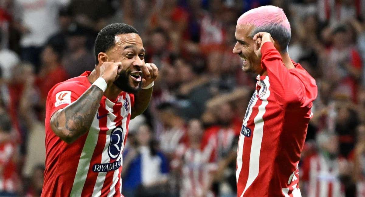 Memphis y Griezmann festejan tapándose los oídos con los dedos, habitual celebración del neerlandés con sus tantos, en el partido ante el Granada. /AFP
