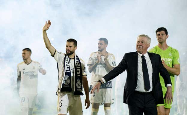 Ancelotti, Nacho y Courtois saludan a la afición.  REUTERS