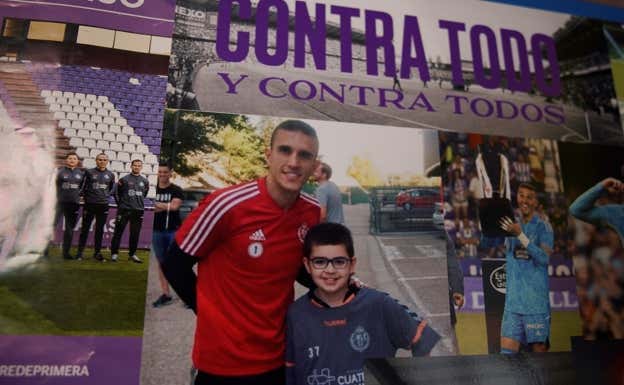 La foto de Miguel con Jordi Masip que preside la pared trasera de su habitación.  SALVADOR FENOLL / RELEVO