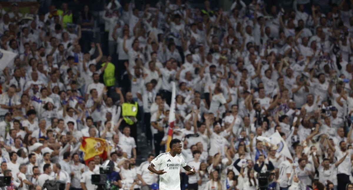 Vinicius, con la Grada Fans RMCF detrás en el partido ante el Borussia Dortmund.