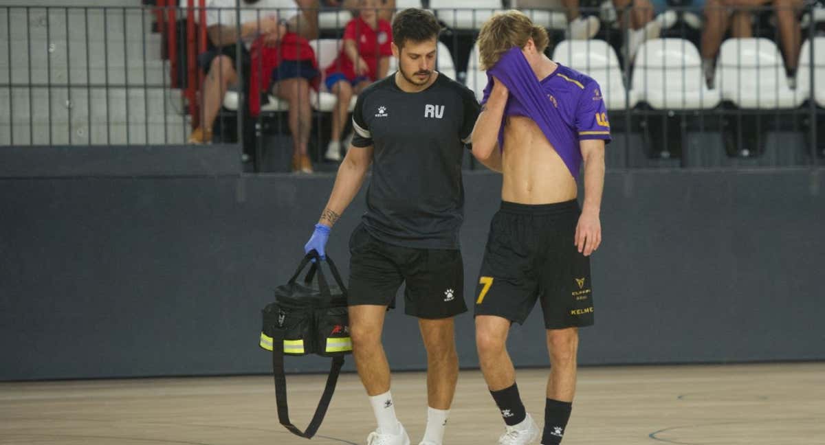 El fisioterapeuta de Industrias Santa Coloma, Raúl Valero, atiende a un jugador a pie de pista.